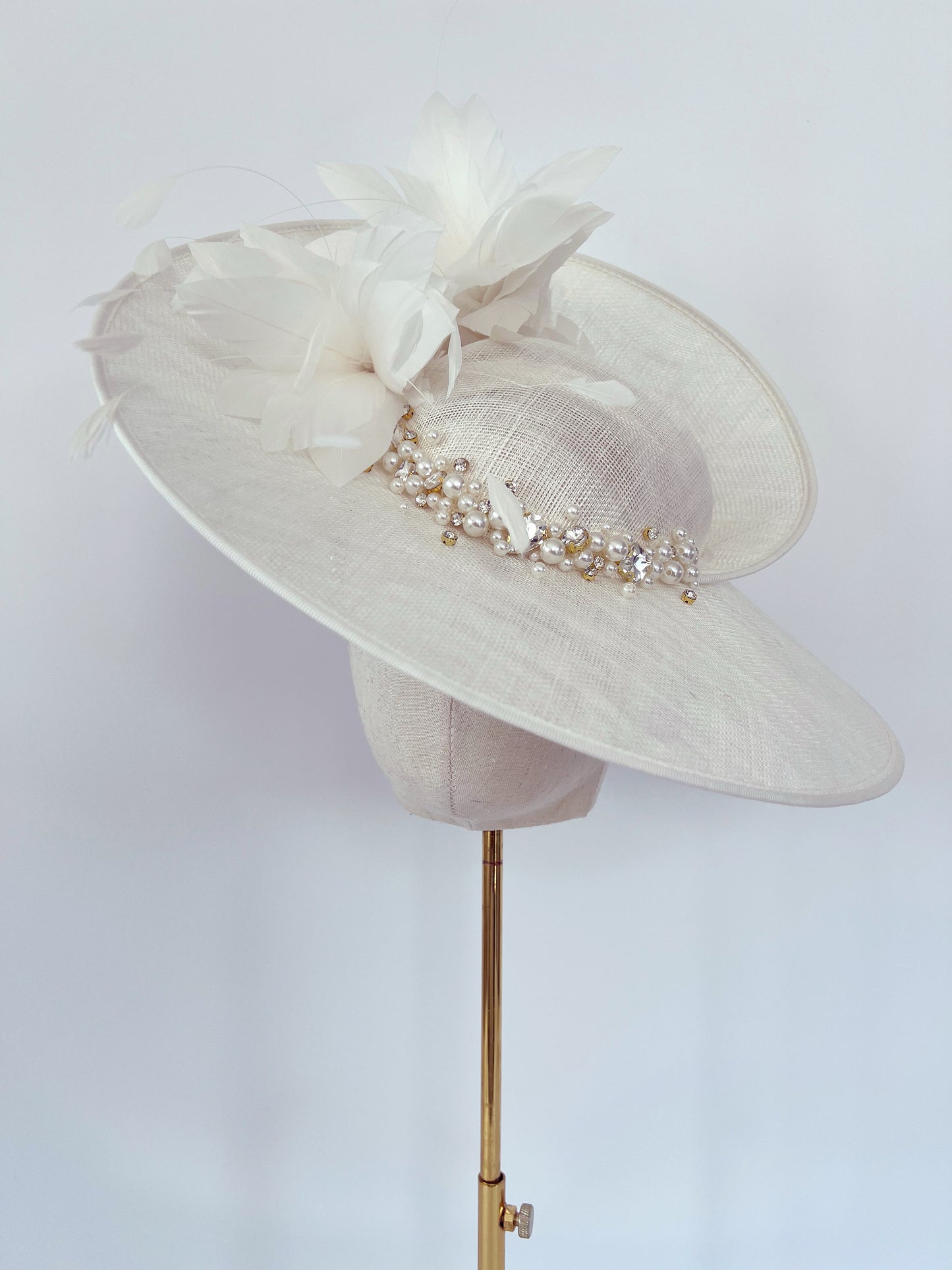 Ivory Hat adorned with Feathers